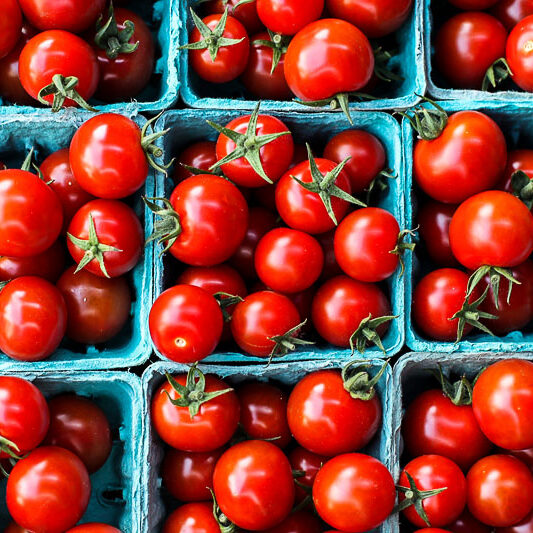 Red tomatoes from farms market in paper containers Red tomatoes from farms market in paper containers